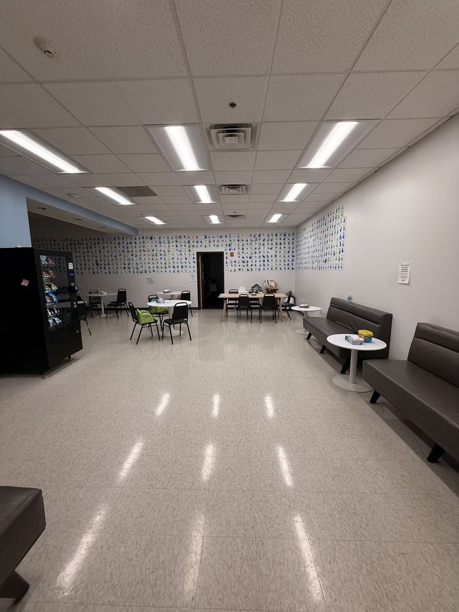 High-gloss VCT floor in a lounge after strip and wax in Lowell, MA